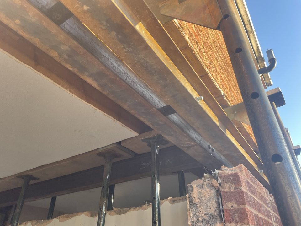Steel beam installed over a newly formed structural opening