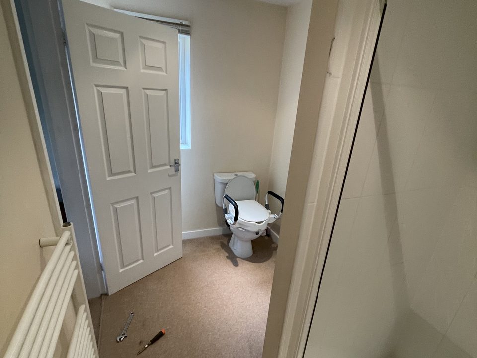 Finished shower room with a wall hung basin and glass screen