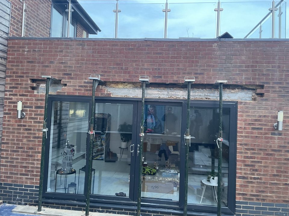 Completed extension with bifold doors against a clear sky