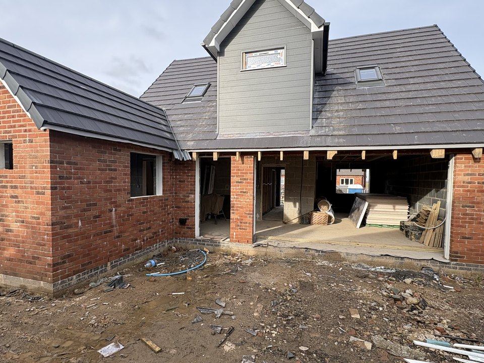 Completed new build in brick with a tiled roof and carport