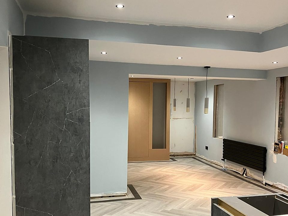 Finished interior with a dark marble panel and herringbone floor